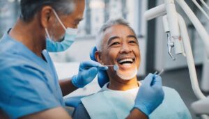 Person holding a small broken tooth fragment in a container beside gauze and a cold compress.